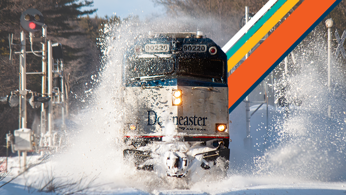 Train moving through snow landscape in New England.