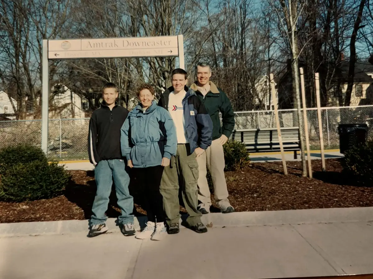 family standing in front of exeter sign