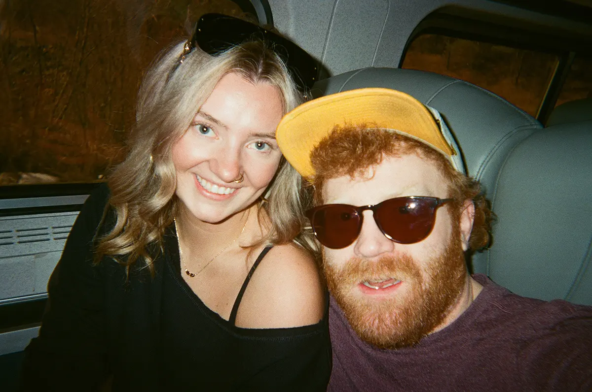 a girl and guy smiling on the train