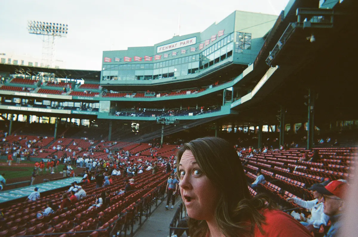 girl making a fun face at a red sox game